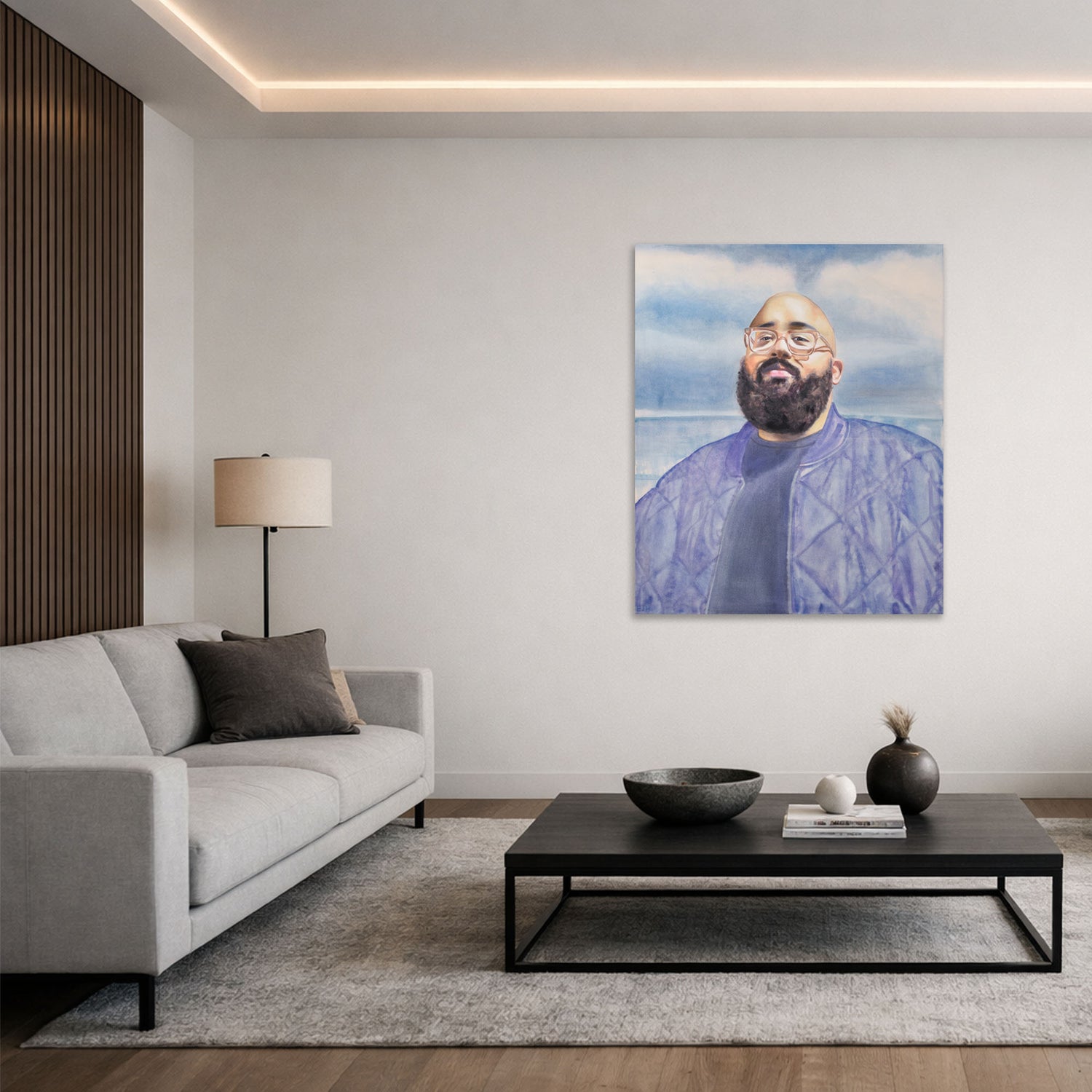 'Adrian Eagle' oil painting of a man hanging in a modern living room with a grey sofa, coffee table and lamp.