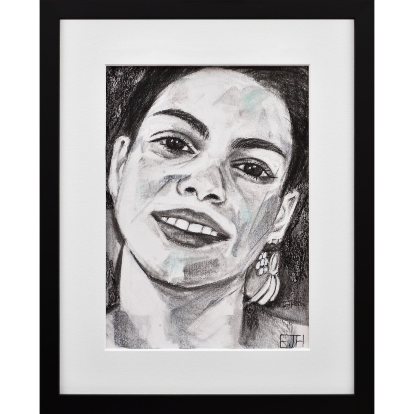 Framed portrait drawing titled 'Charisma', 2024 depicting a female subject with a smile and earring.