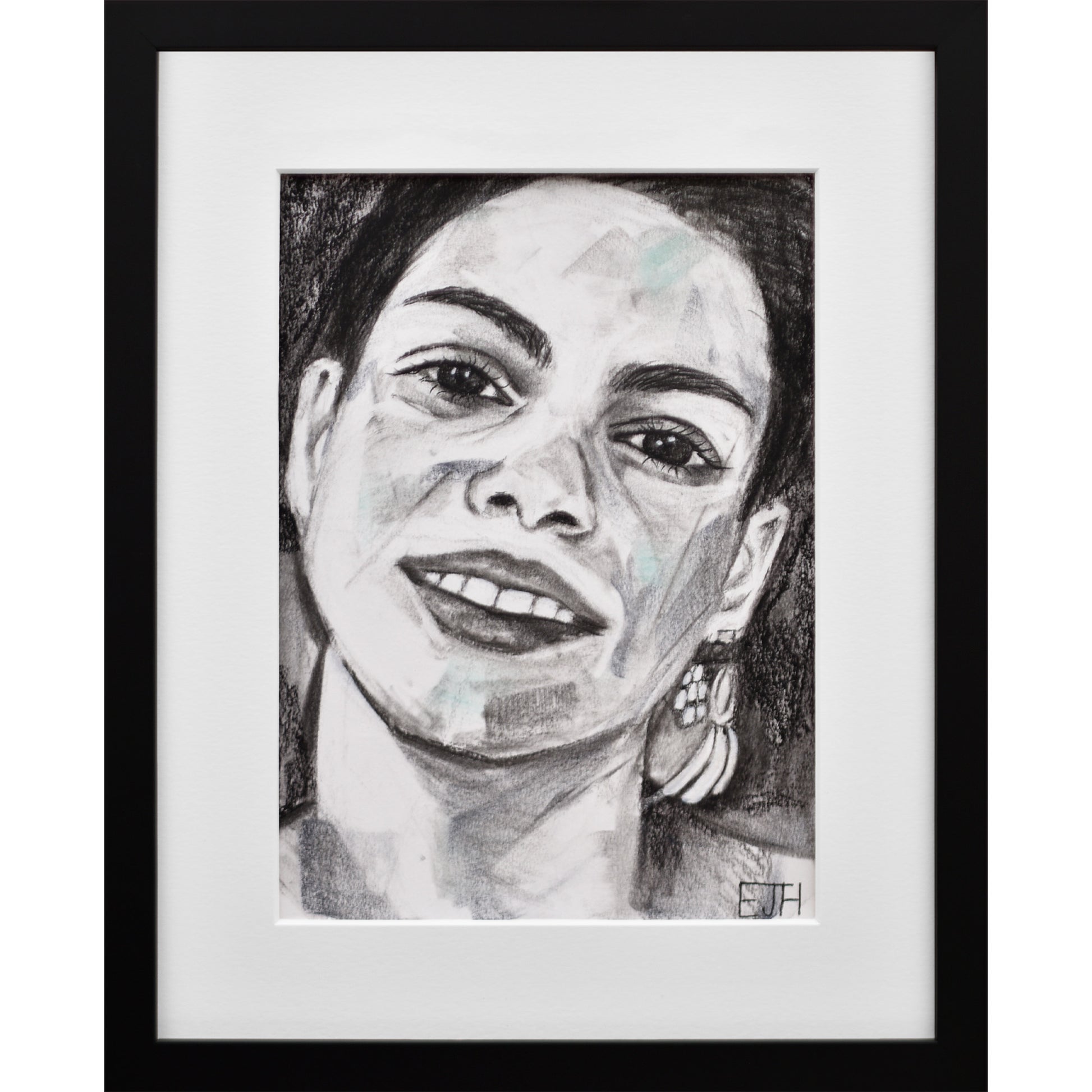 Framed portrait drawing titled 'Charisma', 2024 depicting a female subject with a smile and earring.