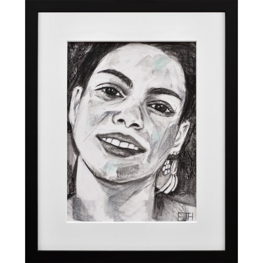 Framed portrait drawing titled 'Charisma', 2024 depicting a female subject with a smile and earring.