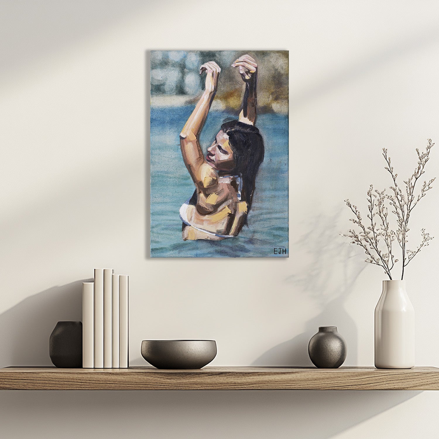 'Golden Hour' oil painting of a woman in the ocean with arms raised hanging above a shelf with decorative items.