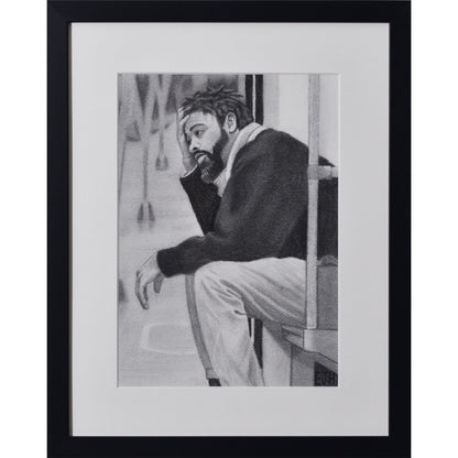 Framed portrait drawing titled 'Lost In My Head', 2025 depicting a man sitting on a metro seat.