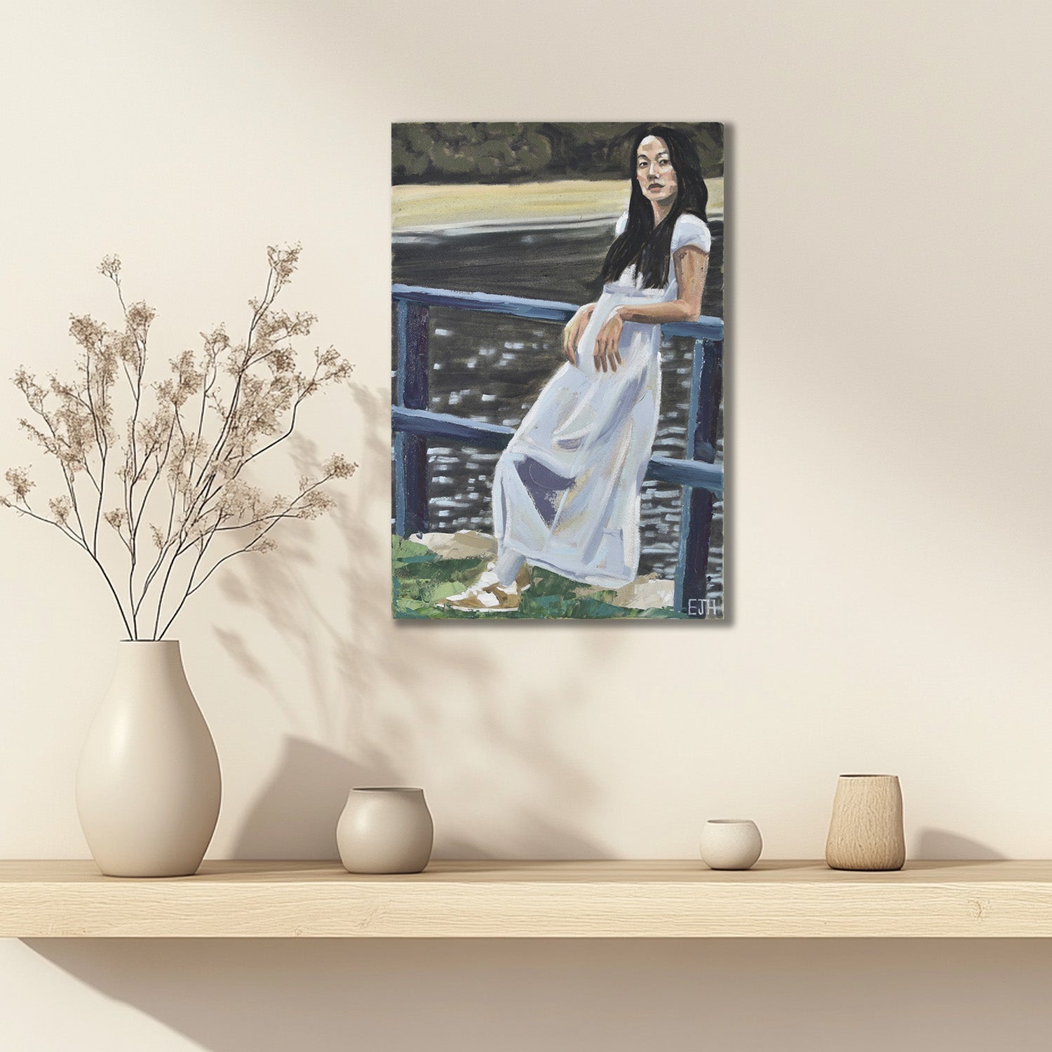 'Near Lavendar Bay' oil painting of a woman in a white dress displayed on a wall above a shelf with decorative vases.