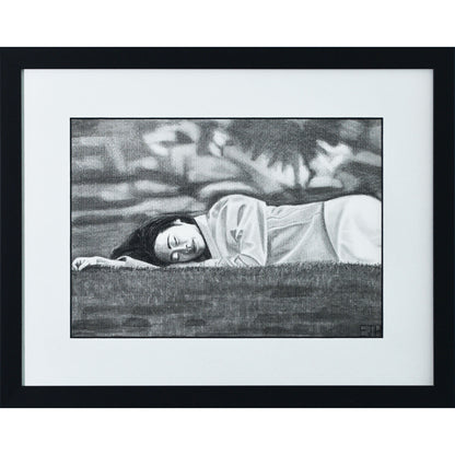 Framed portrait drawing titled 'Passing Of Time', 2025 depicting a female subject lying on grass with an abstract blurry background.