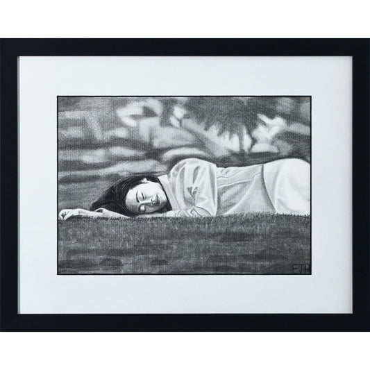 Framed portrait drawing titled 'Passing Of Time', 2025 depicting a female subject lying on grass with an abstract blurry background.
