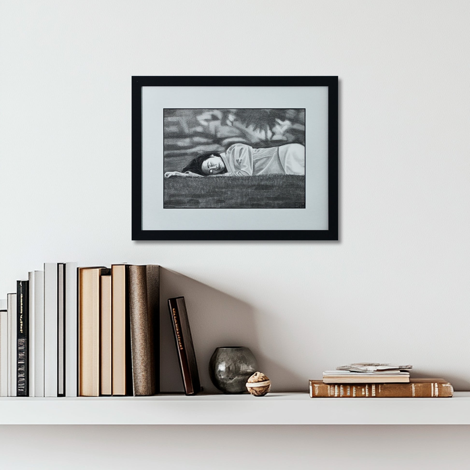 'Passing Of Time' framed portrait drawing hanging on a wall above a shelf with books and decorative items.