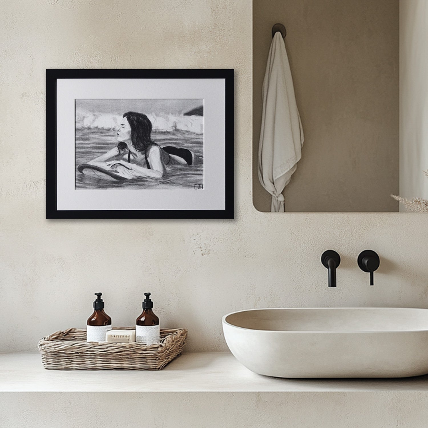 'Soul Surfer' framed portrait drawing of a woman in water hanging in a bathroom with sink and toiletries.