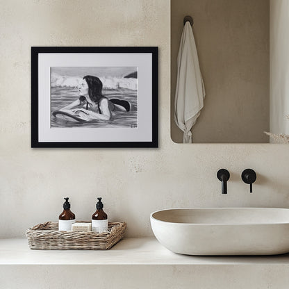 'Soul Surfer' framed portrait drawing of a woman in water hanging in a bathroom with sink and toiletries.