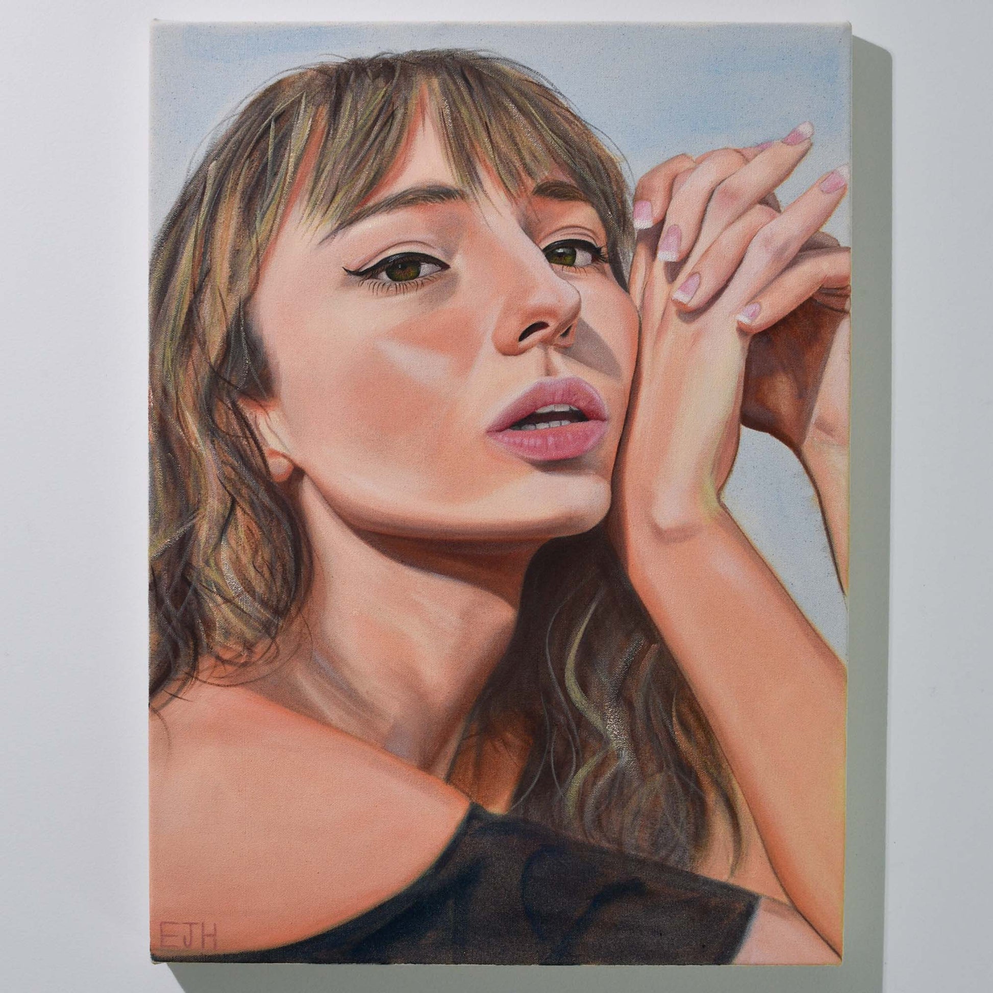 'Sunbleached Girl' oil painting hanging on a neutral wall in the artist's studio.